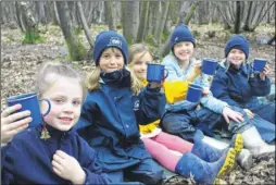  ??  ?? Children from Spring Grove School, Wye, which has been recognised by the Forest School Associatio­n