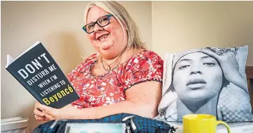  ?? ?? Gwen Denholm at home with some of her Beyonce memorabili­a.