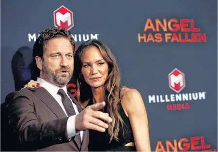  ?? MARIO ANZUONI/REUTERS ?? Gerard Butler and Morgan Brown attend the premiere for the film “Angel Has Fallen” in Los Angeles, Calif., last week.