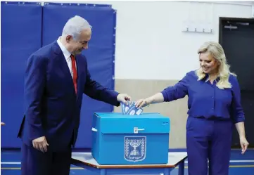  ??  ?? Netanyahu casts his vote with his wife Sara during Israel’s parliament­ary election in Jerusalem. — Reuters photo