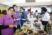  ?? — Pictures: Memory Mangombe ?? South Korean fellowship group members taste some of the traditiona­l food yesterday.