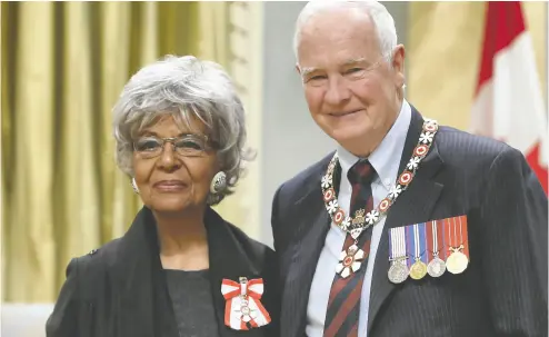  ?? FRED CHARTRAND / THE CANADIAN PRESS ?? Eleanor Collins of Surrey, B.C., poses with former governor general David Johnston as she was invested as Member
of the Order of Canada at a ceremony at Rideau Hall in Ottawa, in 2014.