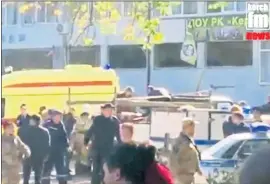  ?? KERCH FM NEWS VIA AP ?? This image made from video shows the scene as emergency services load an injured person onto a truck after a shooting attack in Kerch, Crimea, on Wednesday.