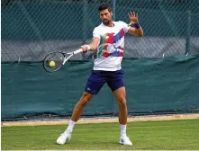  ?? JOHN WALTON / PA ?? Novak Djokovic will have the honor of opening play at Centre Court as the defending champion. He is seeded No. 1 and will be bidding for a fourth consecutiv­e title at the All England Club and seventh overall.