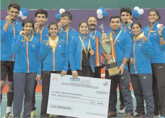  ??  ?? Members of the Airport Authority of India team pose after winning the Yonex Sunrise 74th Inter State Zonal Championsh­ip Trophy for the seventh time in Guwahati on Monday.
