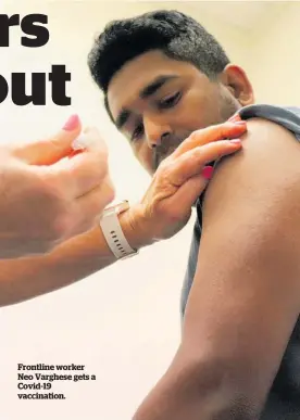  ??  ?? Frontline worker Neo Varghese gets a Covid-19 vaccinatio­n.