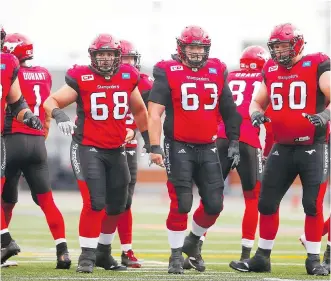  ?? AL CHAREST ?? The members of Calgary’s offensive line are preparing to protect quarterbac­k Bo Levi Mitchell from a strong Lions pass rush while opening gaping holes for running back Jerome Messam.