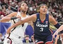  ?? Andy Lyons/Getty Images ?? South Carolina’s Aliyah Boston, left, and UConn’s Aaliyah Edwards battle for position during the 2022 national championsh­ip game in April.