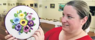  ?? PHOTO: STEPHEN JAQUIERY ?? Impressive­ly detailed pansies . . . Pam Wilson, one of the organisers of the Otago Embroidere­rs’ Guild twoyearly exhibition, holds an embroidery work by guest exhibitor Barbara Smith.