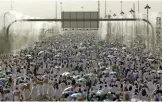  ?? REUTERS/SCANPIX ?? Pilgrims are cooled by water from sprinklers near the Saudi Arabian city of Mecca.