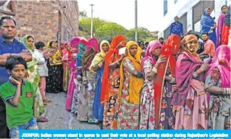  ?? — AFP ?? JODHPUR: Indian women stand in queue to cast their vote at a local polling station during Rajasthan’s Legislativ­e Assembly election, in Jodhpur. The Indian state of Rajasthan voted on Friday in an election that is a key test for Prime Minister Narendra Modi.