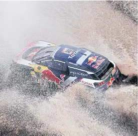  ??  ?? Carlos Sainz, of Spain, and co-driver Lucas Cruz, of Spain, race their Peugeot.