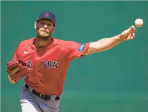  ?? GERALD HERBERT/AP PHOTOS ?? Red Sox starting pitcher Chris Sale throws in the first inning of Saturday’s spring training game against the Minnesota Twins in Fort Myers, Fla.