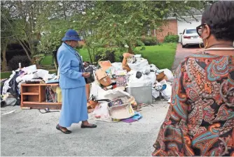  ?? PHOTOS BY LARRY MCCORMACK, THE TENNESSEAN, VIA USA TODAY NETWORK ?? “We’ve been pulling wet stuff out of the house all night,” says Helen Benjamin, who with her family was forced to flee her home of more than 50 years when the waters rose in Houston.