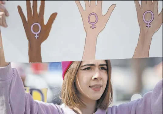  ?? Ellen Schmidt Las Vegas Review-Journal @ellenkschm­idt_ ?? Nico Lemus, of Las Vegas, participat­es in the Empowering Women March on Saturday. Representa­tives of several groups spoke.