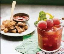  ??  ?? Southerner­s love sweet tea, and they love watermelon. We mix the two into a refreshing summer libation, garnished with lemon, mint and frozen watermelon balls. In the background is fried watermelon rind.