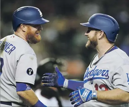  ?? JUSTIN TURNER Ross D. Franklin ?? and Max Muncy were celebratin­g early in the seventh inning after Muncy hit his 20th home run to power L.A.