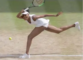  ?? (Photo by Alastair Grant, AP) ?? Venus Williams returns to Johanna Konta during their women's singles semifinal match on day nine at Wimbledon Thursday.