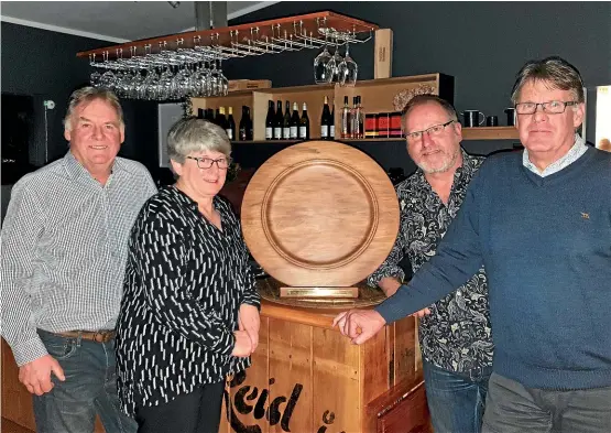  ??  ?? From left, Haydn Ellis, Lynn Mabon and Dave Barrett from Kahurangi Estates, with former co-owner Greg Day and the Colin Harrison Memorial Trophy for the region’s top chardonnay. The judging in this year’s competitio­n was extremely close, with the tiniest difference in taste being the difference in deciding the winner.