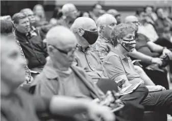  ?? Jason Fochtman / Staff file photo ?? Residents listen to a Sept. 15 panel discussion on cityhood for The Woodlands. Township board members say they have a plan to keep the tax rate consistent over the first few years.