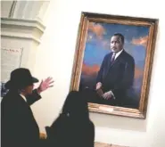  ?? ASSOCIATED PRESS FILE PHOTO ?? People look at the portrait of the Rev. Martin Luther King Jr. on Jan. 17, 2013, following a service celebratin­g King's birthday inside the Georgia State Capitol in Atlanta.