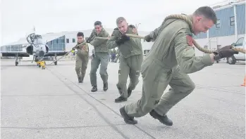  ??  ?? Members of Team Hawk Fuzz, from Groundscho­ol 1706 — namely Anthony Nero, Jeff Ryan, Kevin Burke and Hugh Reynolds (in no order) — work to get the CT155 Hawk across the line during the annual Hawk Pull at 15 Wing.