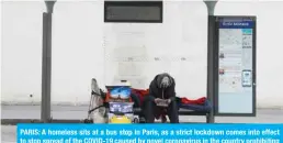  ??  ?? PARIS: A homeless sits at a bus stop in Paris, as a strict lockdown comes into effect to stop spread of the COVID-19 caused by novel coronaviru­s in the country prohibitin­g all but essential outings in a bid to curb coronaviru­s spread. — AFP