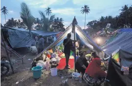  ?? TATAN SYUFLANA /ASSOCIATED PRESS ?? Villagers gather at a temporary shelter on Wednesday after fleeing their village, damaged by an earthquake that hit North Lombok, Indonesia, on Sunday.