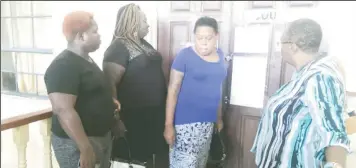  ??  ?? Petronella Trotman (third from left) standing outside of the courtroom of Magistrate Dylon Bess after she was ordered to leave.