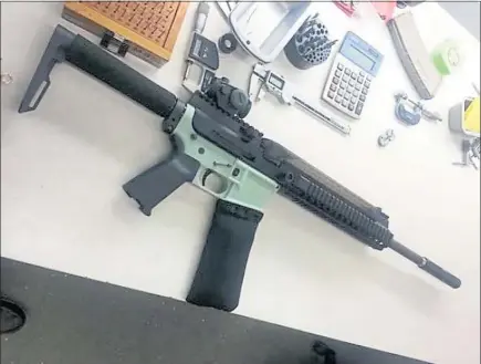  ?? PHOTOS COURTESY OF CODY WILSON ?? Cody Wilson printed this green lower receiver for an AR-15 in November 2012. He was able to shoot the gun several times with the 3-D printed part.