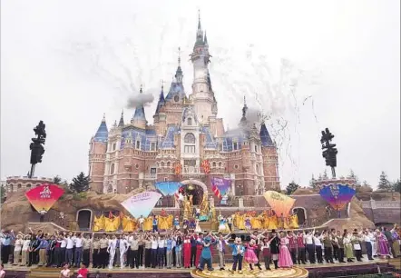  ?? European Press Agency ?? AS FIREWORKS explode over the Enchanted Storybook Castle, entertaine­rs perform at the opening ceremony for the resort.