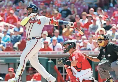  ?? David KOHL/USA TODAY Sports ?? Atlanta Braves designated hitter Marcell Ozuna (20) hits a solo home run against the Cincinnati Reds in the ninth inning against the Cincinnati Reds at Great American Ball Park.