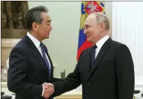  ?? ANTON NOVODEREZH­KIN, SPUTNIK, KREMLIN POOL PHOTO VIA AP ?? Russian President Vladimir Putin greets Chinese Communist Party’s foreign policy chief Wang Yi during their meeting at the Kremlin in Moscow on Wednesday.