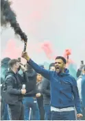  ?? Photo / AP ?? Fans set off flares and invaded Old Trafford ahead of the scheduled Manchester United-Liverpool game.