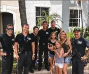  ?? CONTRIBUTE­D BY JEFF DEVER ?? The hero firefighte­rs (from left): John Torchetti, Mauricio Echevery, Chris Dewitt, Julian Stout, Zach Swanson and Greg Rogers; with Hannah, Lila and Lisa Gerard — and Hank in Hannah’s arms.