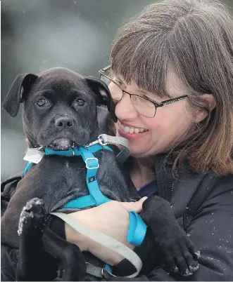  ?? LEAH HENNEL ?? Cheryl Katterhage­n, pictured with her dog Betty, took part in Change Day Alberta last year, pledging to be a volunteer dog walker. The experience had lasting benefits for the health-care profession­al.