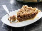  ?? DANIEL J. VAN ACKERE — AMERICA’S TEST KITCHEN VIA AP ?? This undated photo provided by America’s Test Kitchen in October 2018 shows classic pecan pie in Brookline, Mass. This recipe appears in the cookbook “All-Time Best Holiday Entertaini­ng.”