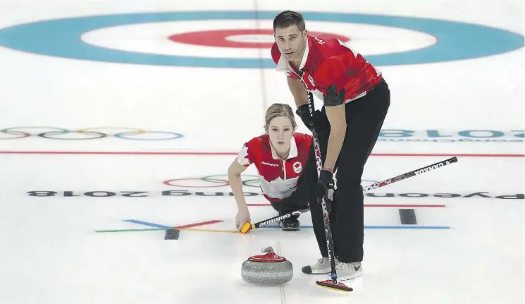  ?? ROBERT CIANFLONE/GETTY IMAGES ?? John Morris and Kaitlyn Lawes improved to 4-1 in the mixed doubles curling tournament at the Pyeongchan­g Games after beating the Swiss team Friday.