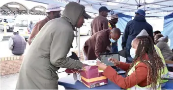  ?? ?? Long-distance taxi drivers in Polokwane gather to check for outstandin­g traffic fines.