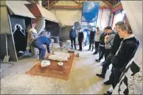  ??  ?? Students look on intently as they are shown the casting process during their foundry tour.