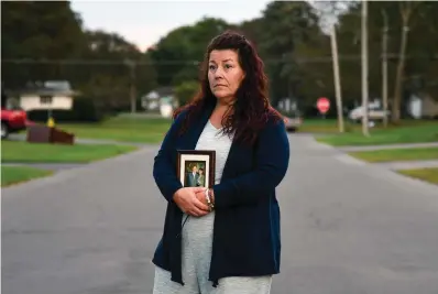  ?? The Associated Press ?? Natalie Walters, 53, holds a photo of her parents, Jack and Joey Walters, on Sept. 21 near her home in Syracuse, N.Y. Walters’ father, who was staying at the Loretto Health and Rehabilita­tion nursing home in Syracuse, died of COVID-19 in December 2020. The facility’s staffing has declined during the pandemic and Walters wonders if poor staffing played a role in her father’s infection or death. Nationwide, one-third of U.S. nursing homes have fewer nurses and aides than before COVID-19 began ravaging their facilities, an Associated Press analysis of federal data finds.