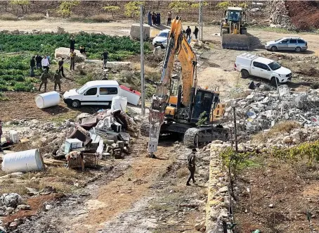  ?? Reuters ?? Israeli machinery demolishes a Palestinia­n house in Hebron in the Israeli-occupied West Bank amid the recent surge in violence in the conflict.