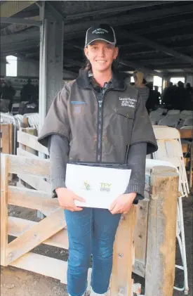  ??  ?? EMMA Lewin with her award, wearing the jacket she won as Tararua Shepherd of the Year on Friday April 27 at the Greenhill Station Field Day.