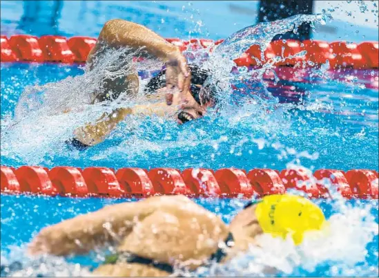  ?? Robert Gauthier Los Angeles Times ?? KATIE LEDECKY, top, is outdueled by Australia’s Ariarne Titmus, bottom, who won gold in the 400-meter freestyle and relegated the American star to second.