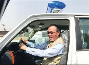  ?? JAPANESE EMBASSY/AFP ?? Japanese Ambassador Fumio Iwai rides in a pick-up truck during a handover ceremony of vehicles provided by Japan to the Iraqi police earlier this year.