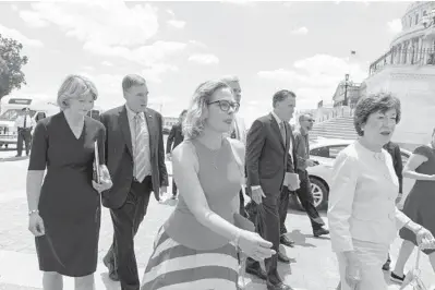  ?? ALEX BRANDON/AP ?? A bipartisan group of senators returns to the Capitol after meeting with President Joe Biden at the White House.