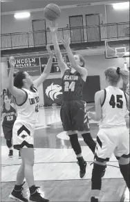  ?? MIKE ECKELS NWA NEWSPAPERS ?? Decatur’s Sammie Skaggs (No. 24) puts up a jumper over Lady Wolves’ Robin Kirk (No. 42) and Jessia Goldman (No. 45) during the third quarter of the Decatur-Lincoln varsity basketball contest at Lincoln High School Nov. 19. The Lady Bulldogs and Lady Wolves contest was part of the first round of the first Annual Turkey Shoot tournament action.