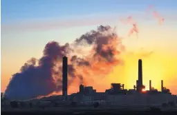  ?? J. DAVID AKE/ASSOCIATED PRESS ?? The Dave Johnson coal-fired power plant is silhouette­d against the morning sun in Glenrock, Wyo., in 2018. A coalition of states has sued the Trump administra­tion over its decision to ease restrictio­ns on coal-fired power plants.