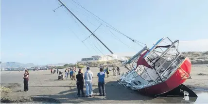  ?? Photo / Kurt Bayer ?? A yacht lies on the beach at New Brighton, Christchur­ch, after the owner swam to shore.