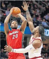  ?? GREGORY SHAMUS/GETTY IMAGES ?? Justise Winslow of the Heat takes a shot over Jae Crowder of the Cavs during Cleveland’s blowout win.